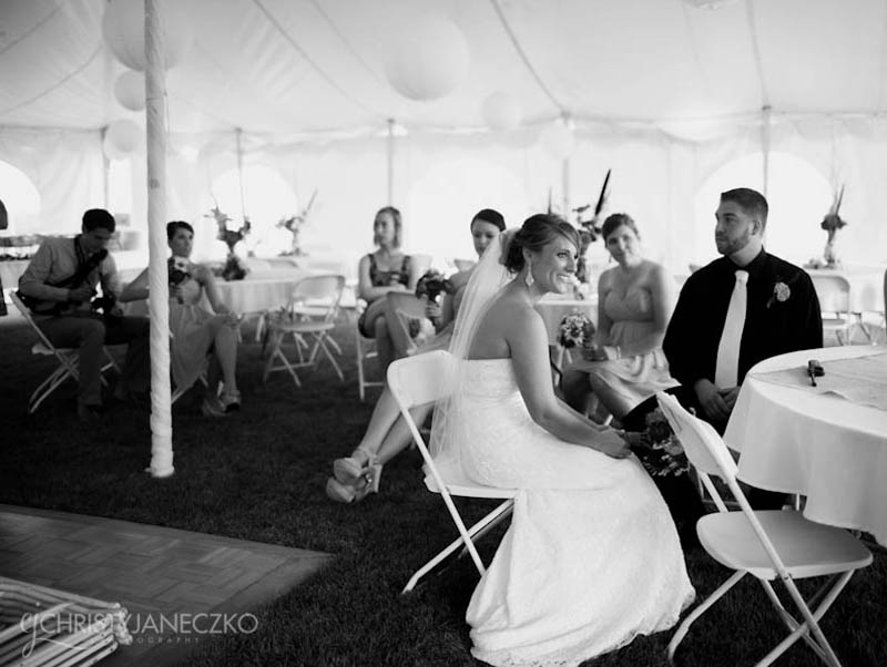 bride and groom wait out the rain in tent