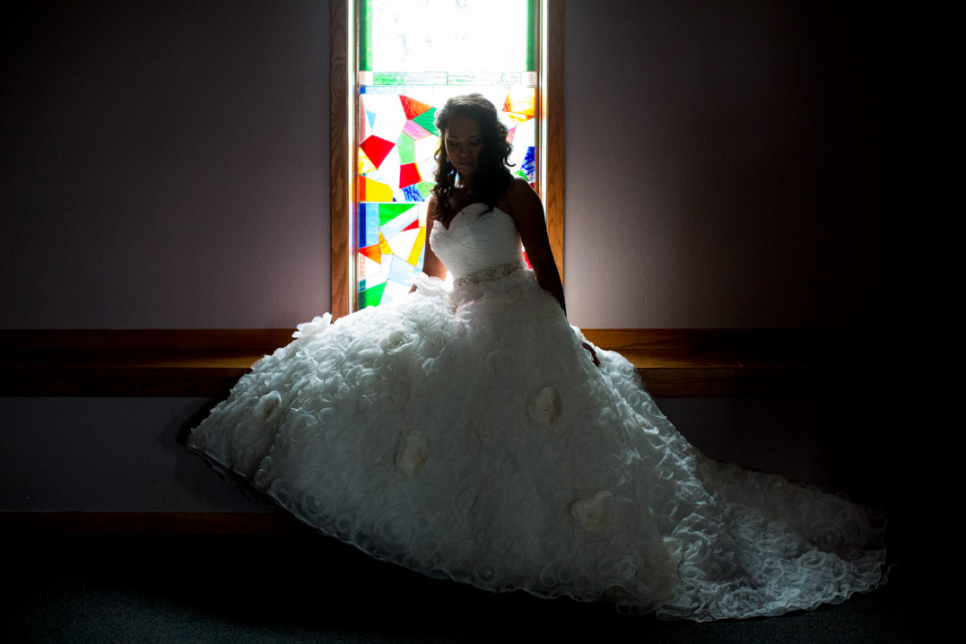bride with stained glass window harvestime church eau claire wi
