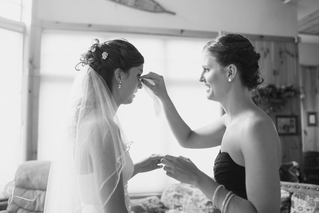 bride and twin sister getting ready on wedding day