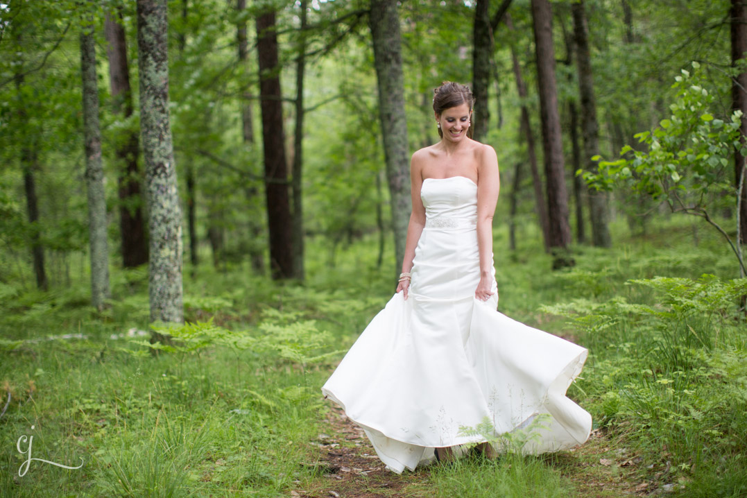 bride twirling in forest on wedding day