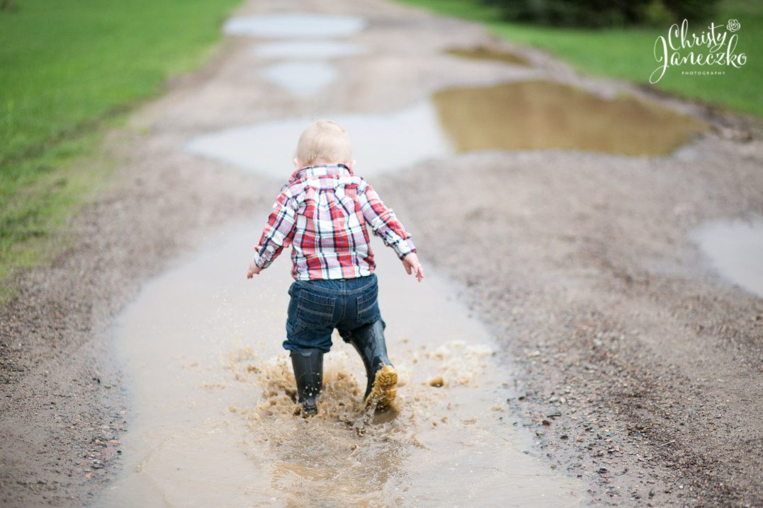 toddler splashing in puddles