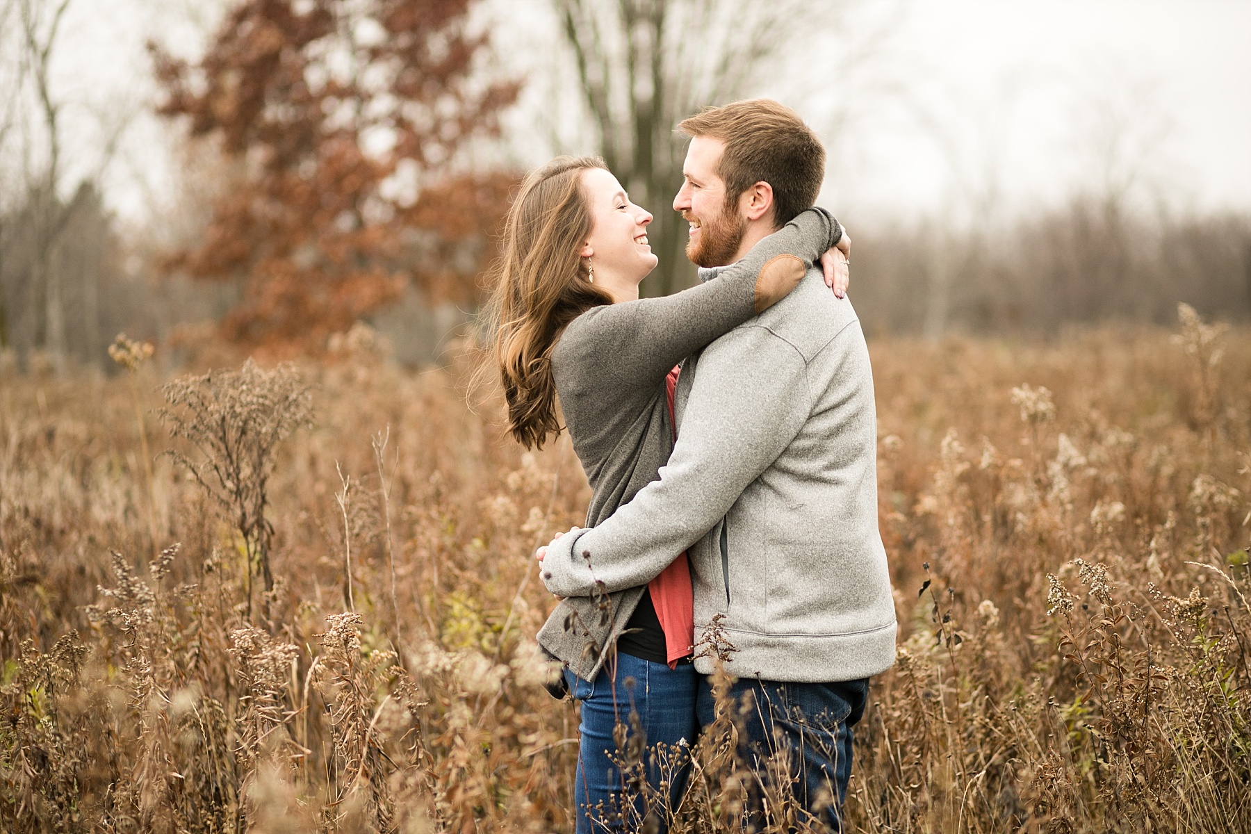 A stroll through a field in a flowing blue dress was perfection for Amber & Dillon's late fall Wisconsin engagement photos.