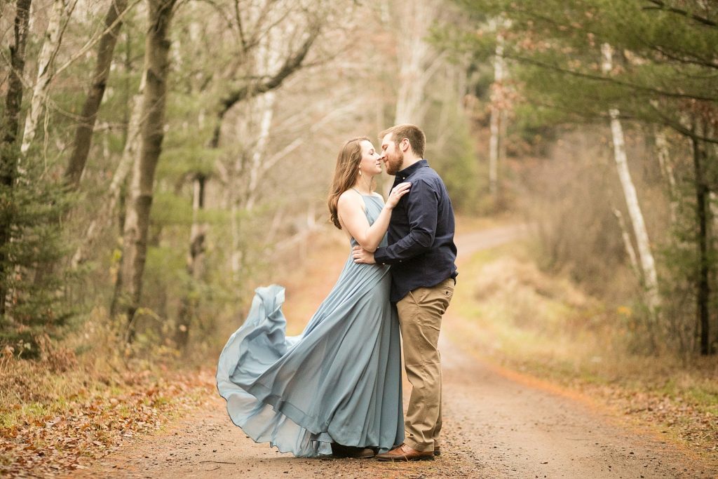 A stroll through a field in a flowing blue dress was perfection for Amber & Dillon's late fall Wisconsin engagement photos.