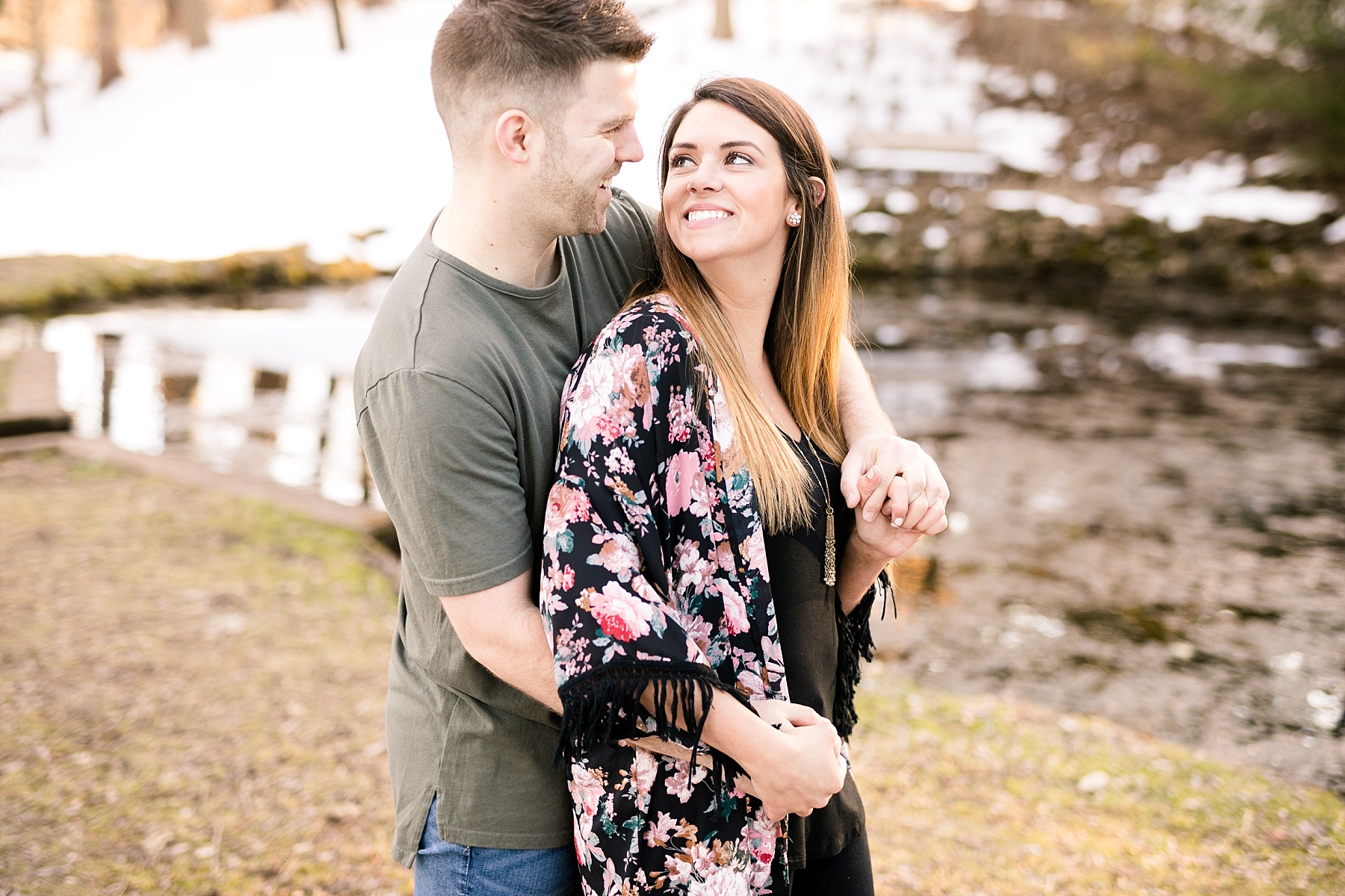 Emily & Blake's sun filled spring outdoor Eau Claire engagement session is sprinkled with snow and spring warmth.