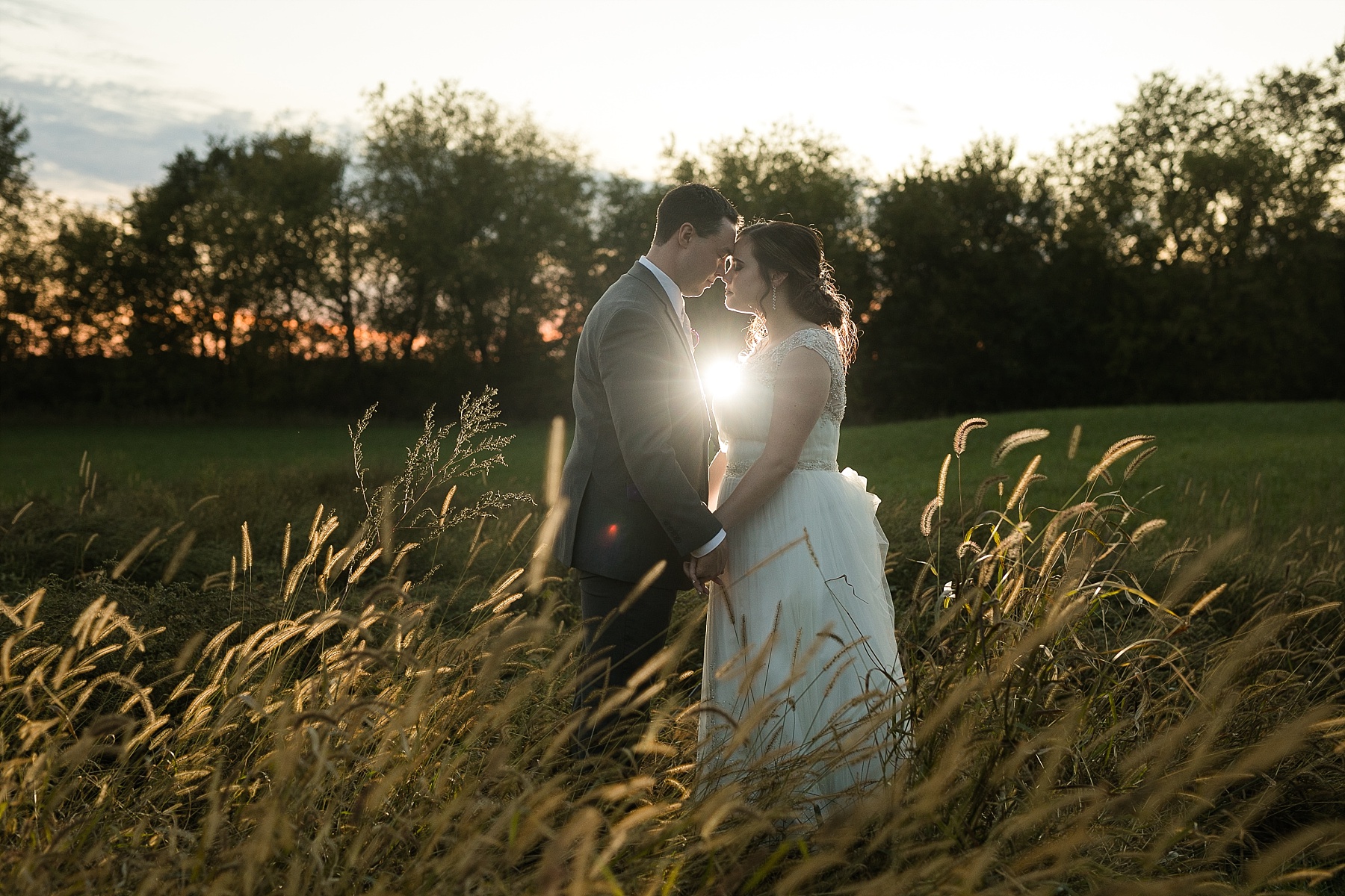 bride and groom in the field at Celebrations at the Gables