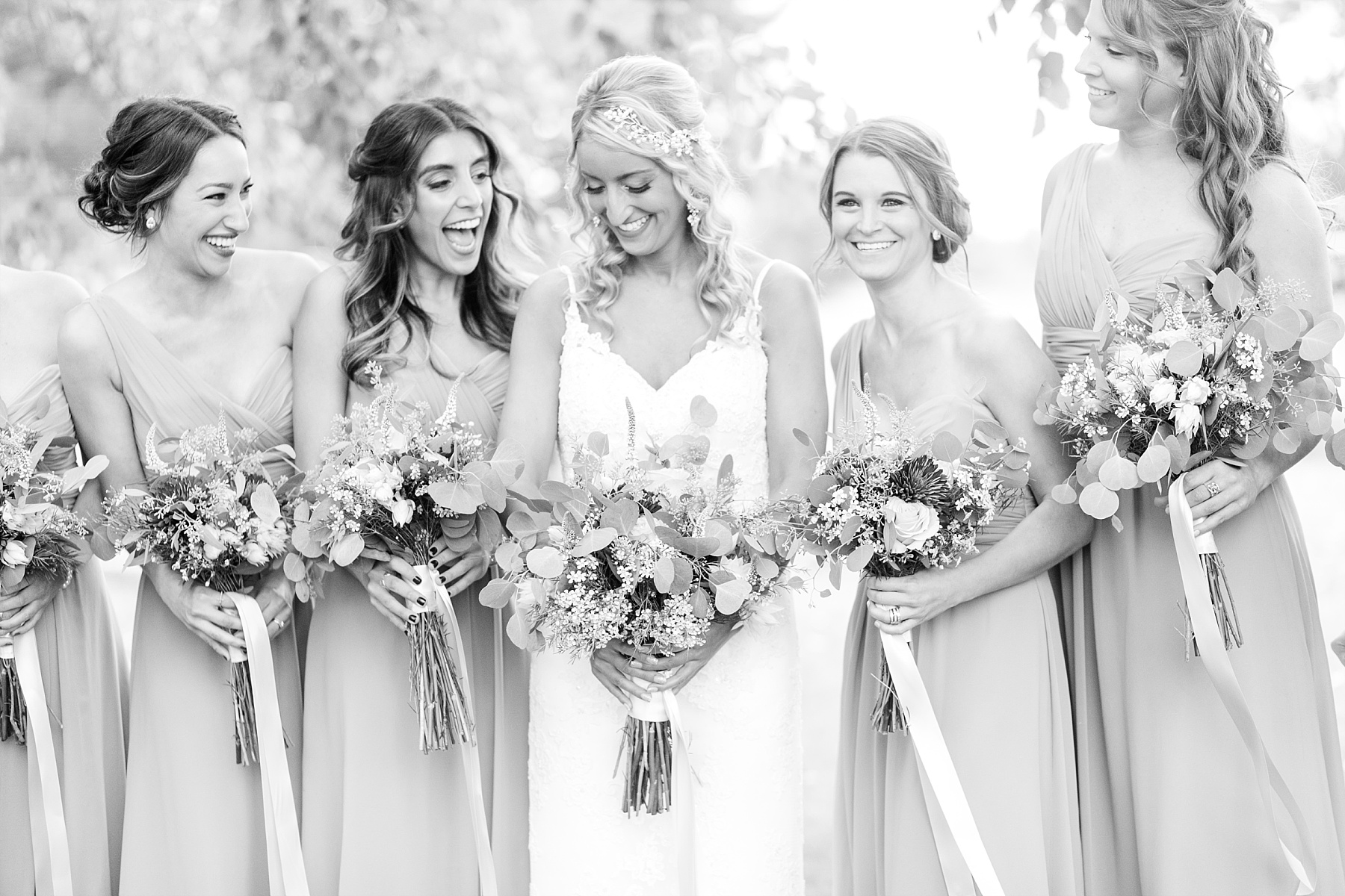 bride and bridesmaids laughing at Lake Wissota Golf & Events