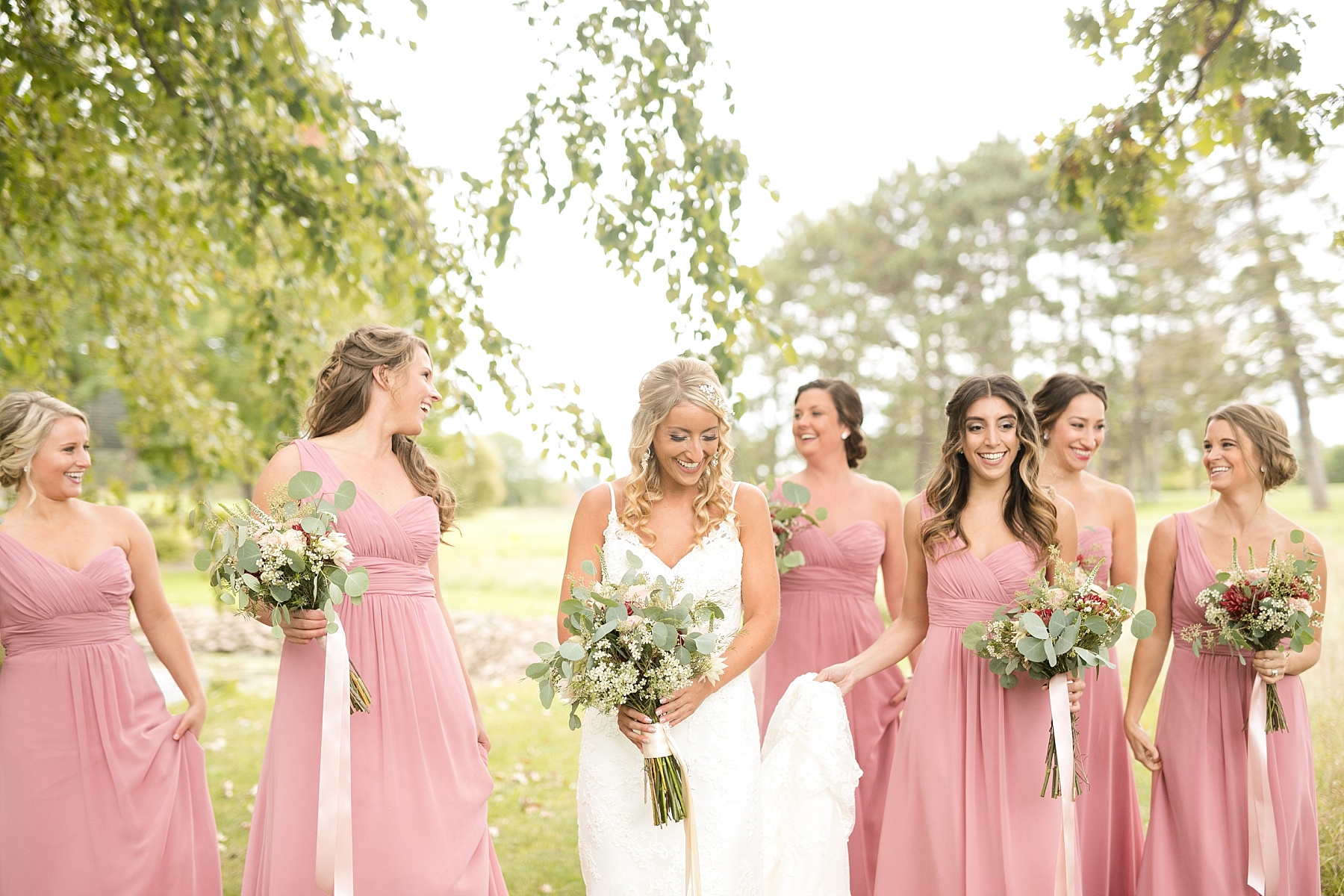 bride and bridesmaids walking outside at Lake Wissota Golf & Events