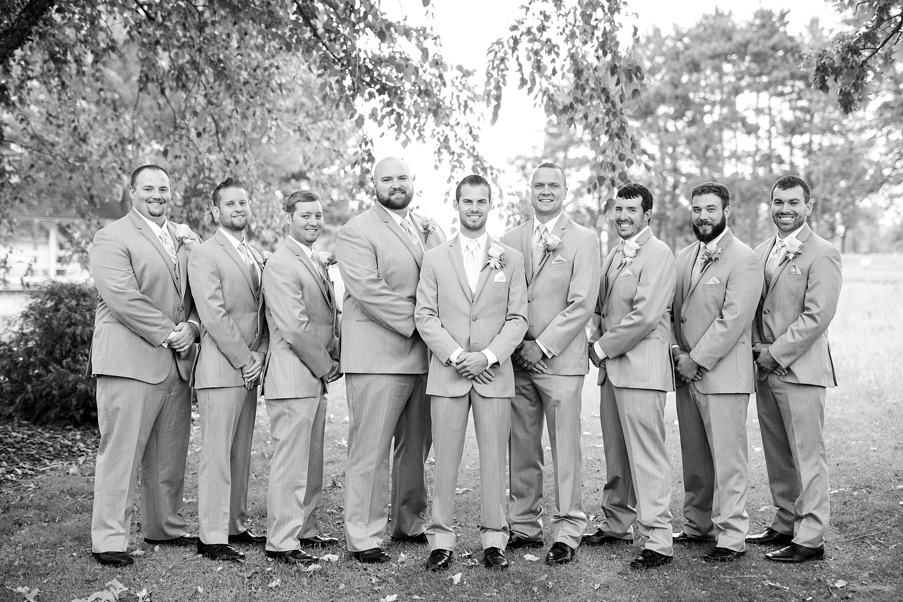 groom and groomsmen posing in a black and white photo at Lake Wissota Golf & Events