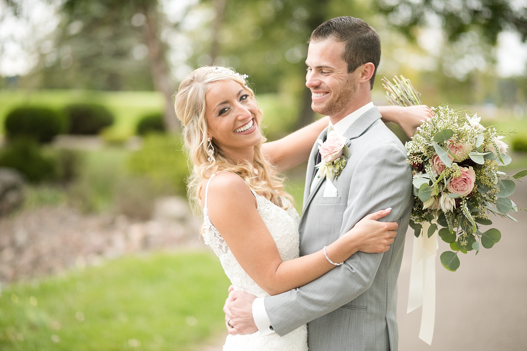 bride and groom laughing together at Lake Wissota Golf & Events
