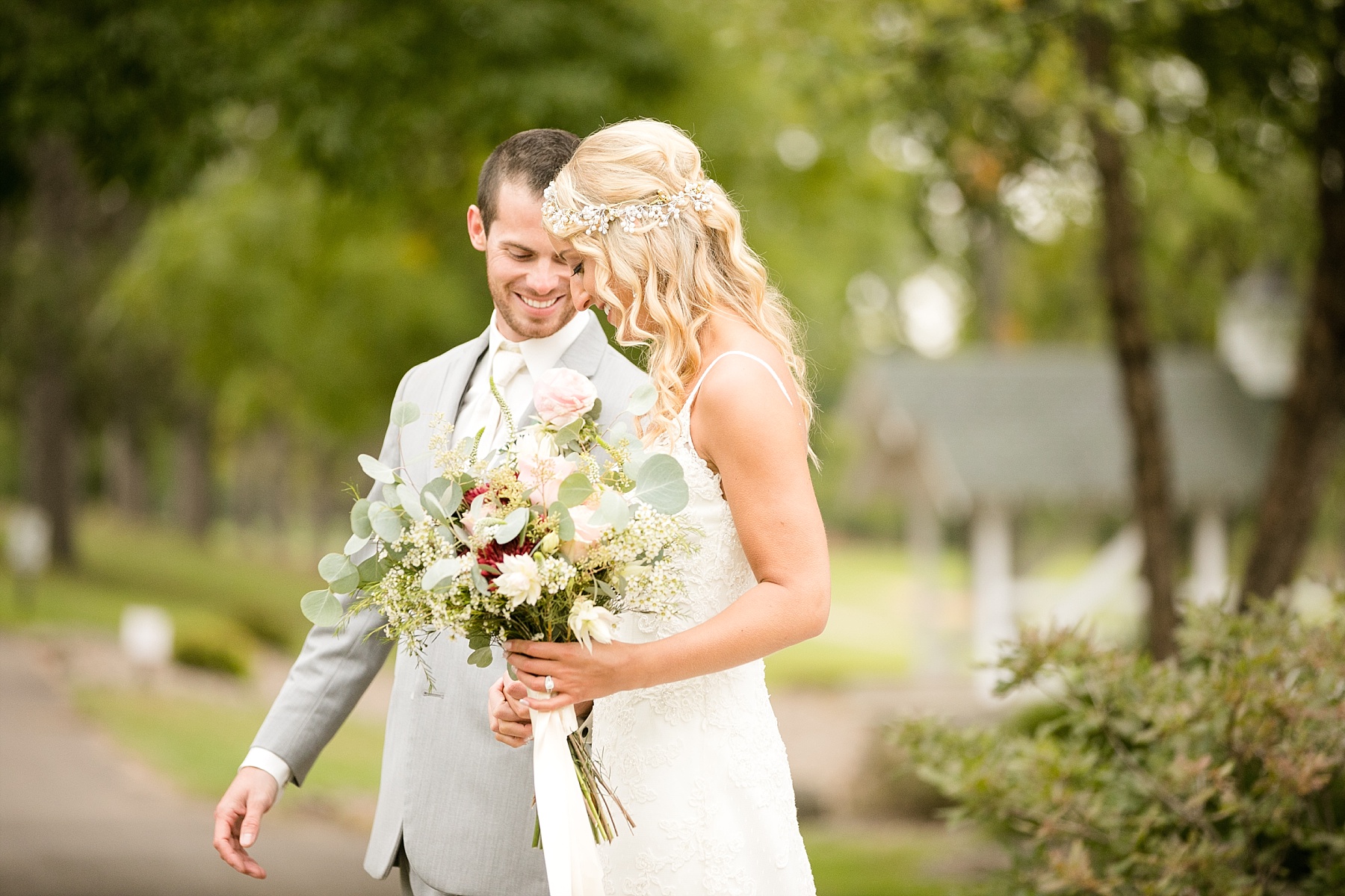 bride and groom walking together at Lake Wissota Golf & Events