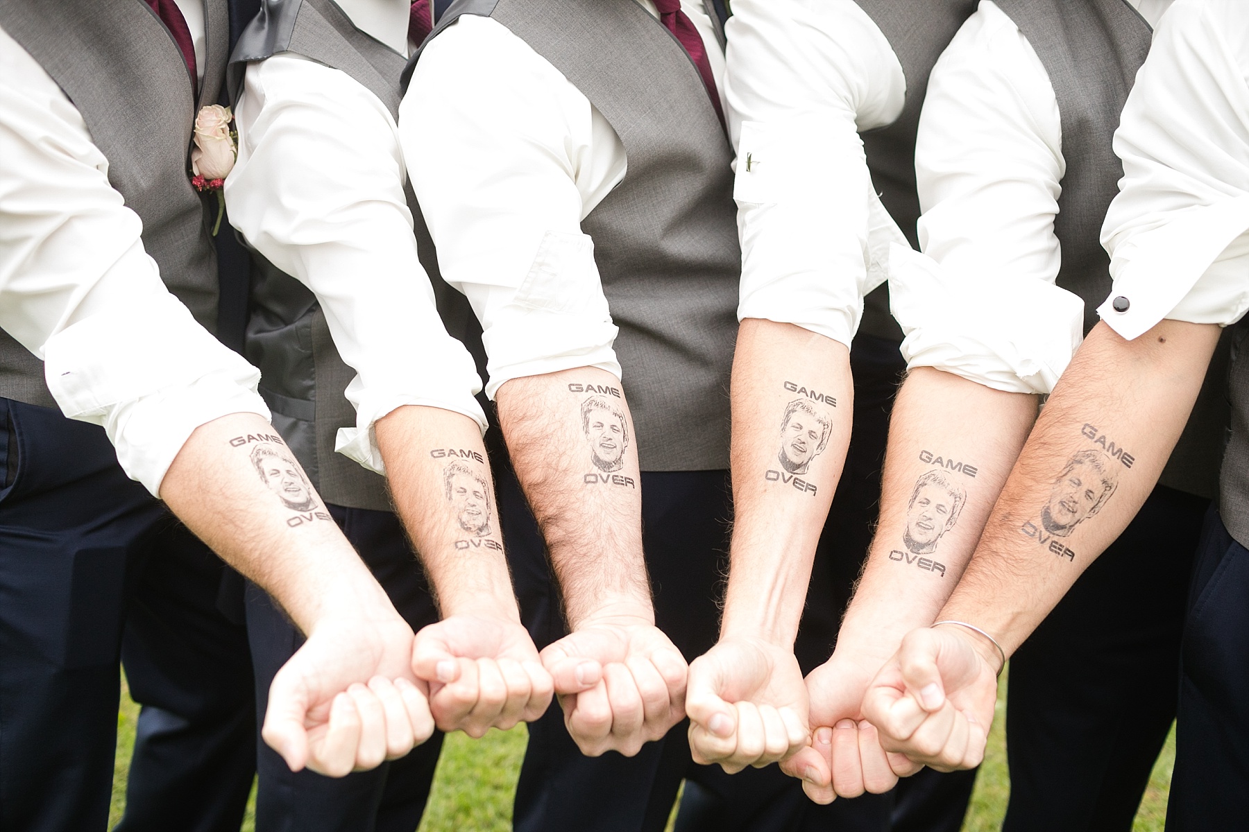groomsmen with temporary tattoos saying game over