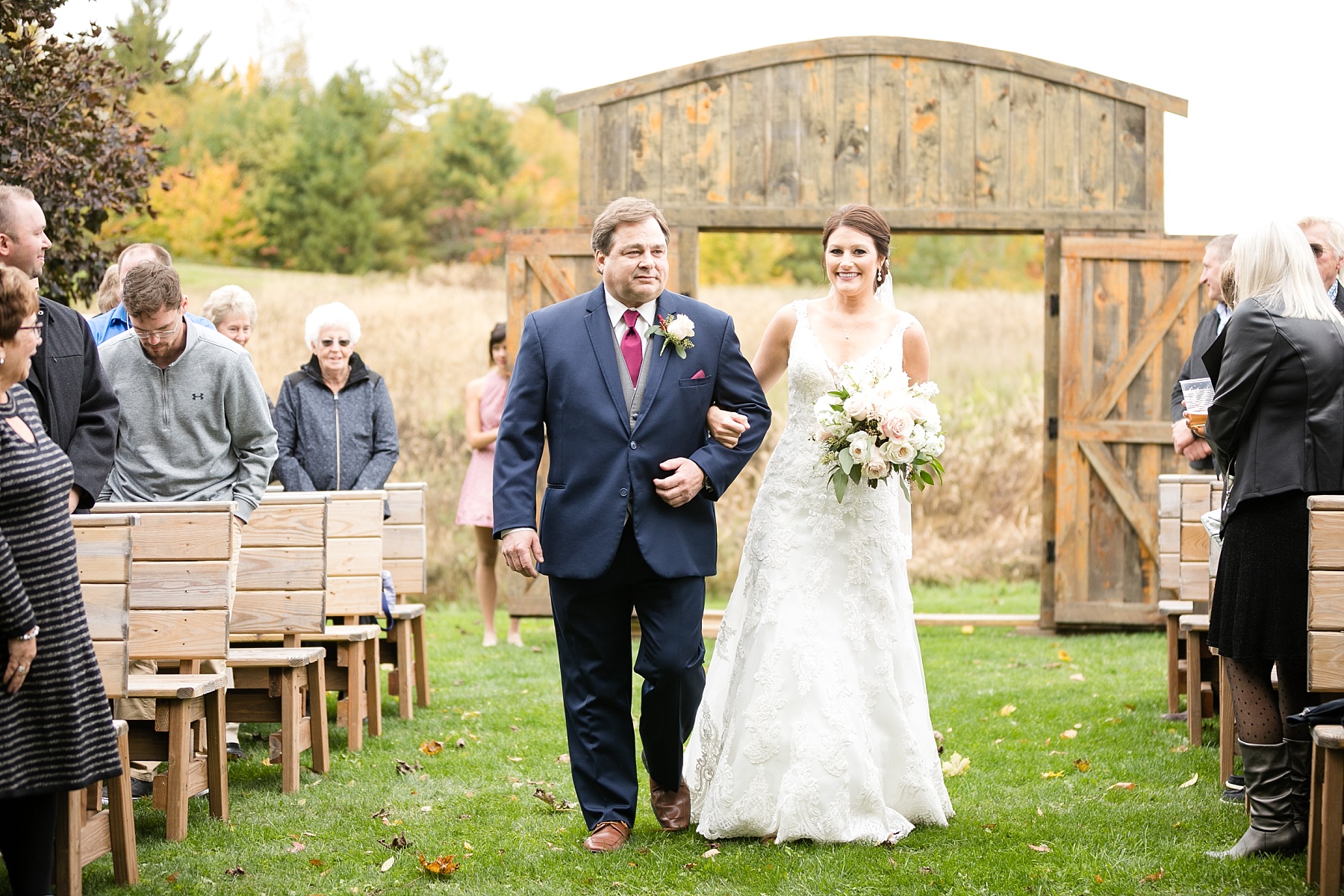 bride and father walking down the aisle at the barn on stoney hill