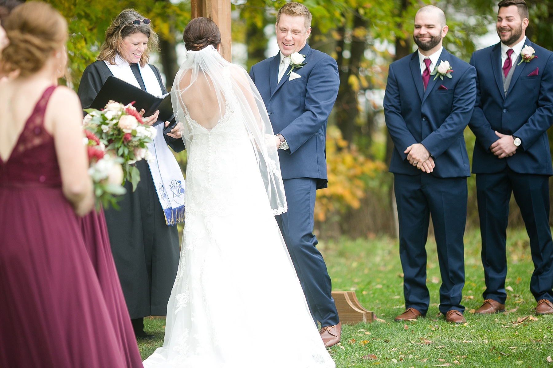 groom laughing during the ceremony at the barn on stoney hill