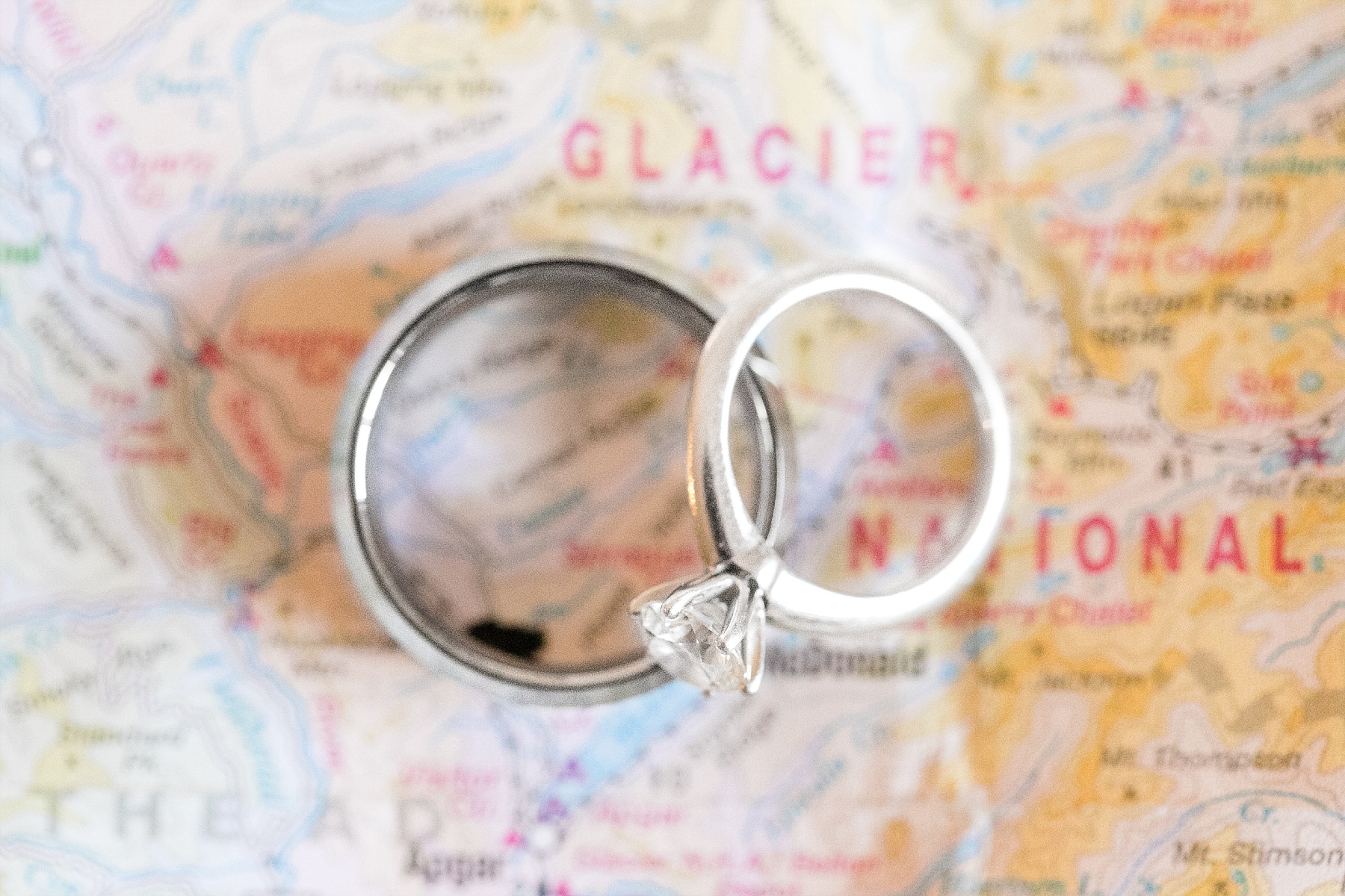 bride and grooms rings on map of Glacier National Park
