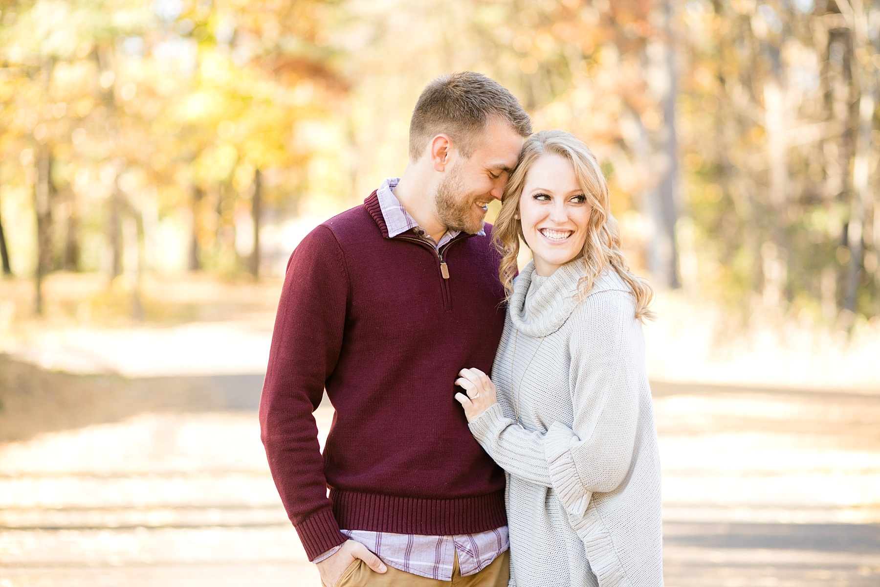 girl laughing and snuggling for Irvine Park engagement pictures