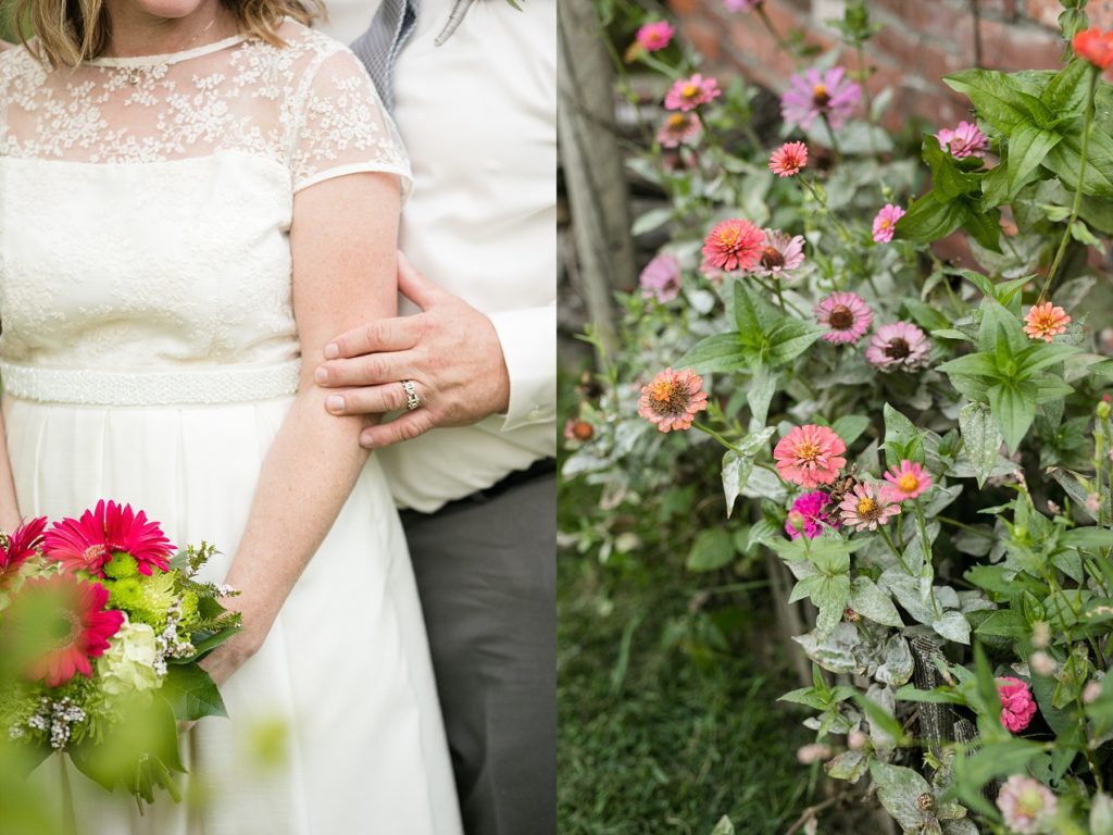 detail shot of a groom touching the brides arm after eloping and a flower bed at cottage winery and vineyard.