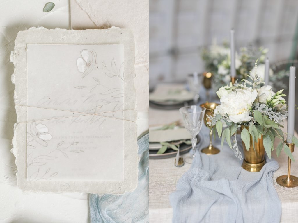handmade paper and vellum invitation tied together with gold thread and a tablescape in colors of blue and brass