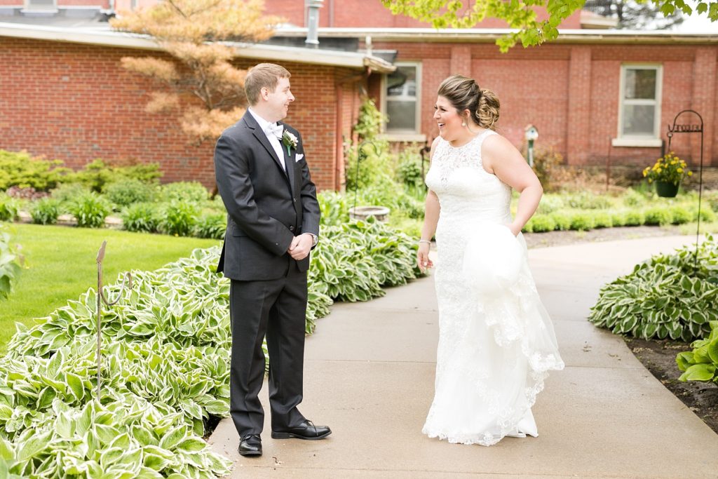 bride and groom outside on a rainy wedding day at Wedding at St. Raphael & St. Patrick Cathedral in Dubuque
