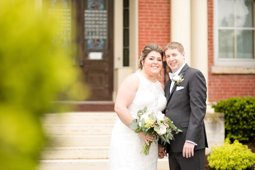 bride and groom outside cathedral at Wedding at St. Raphael & St. Patrick Cathedral in Dubuque