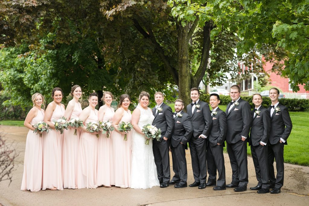bridal party on a rainy wedding day in Dubuque near the cathedral