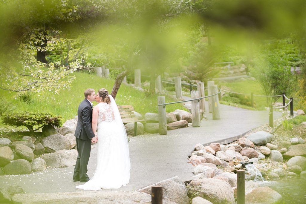 couple kissing on their wedding day at Dubuque Arboretum