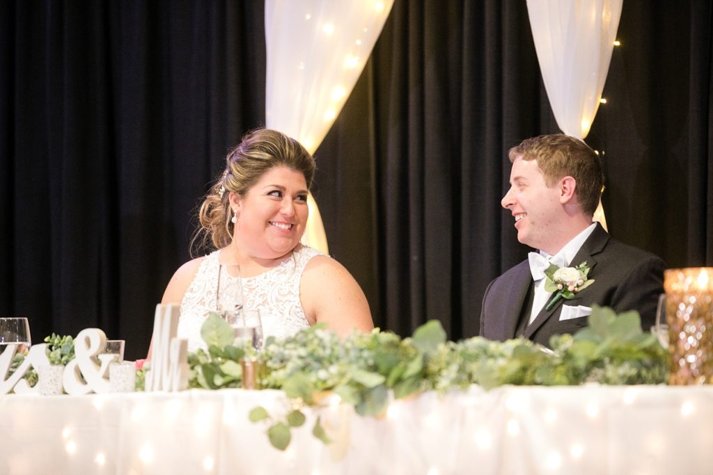 couple smiling at each other during toasts for wedding at UW-Platteville Ullsvik Hall
