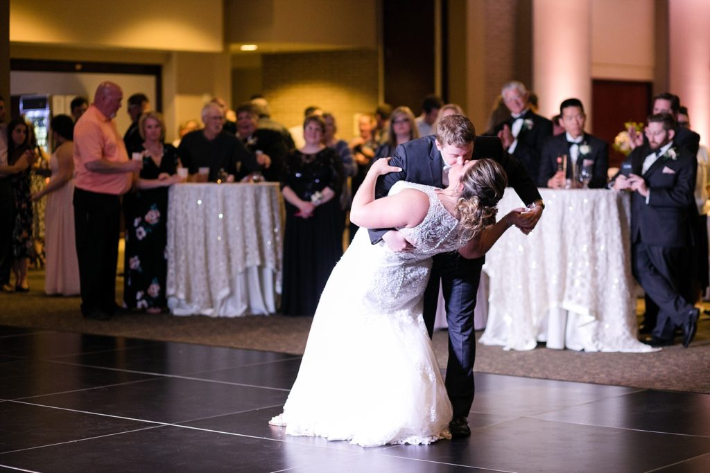 groom dips the bride during first dance at a wedding at UW-Platteville Ullsvik Hall