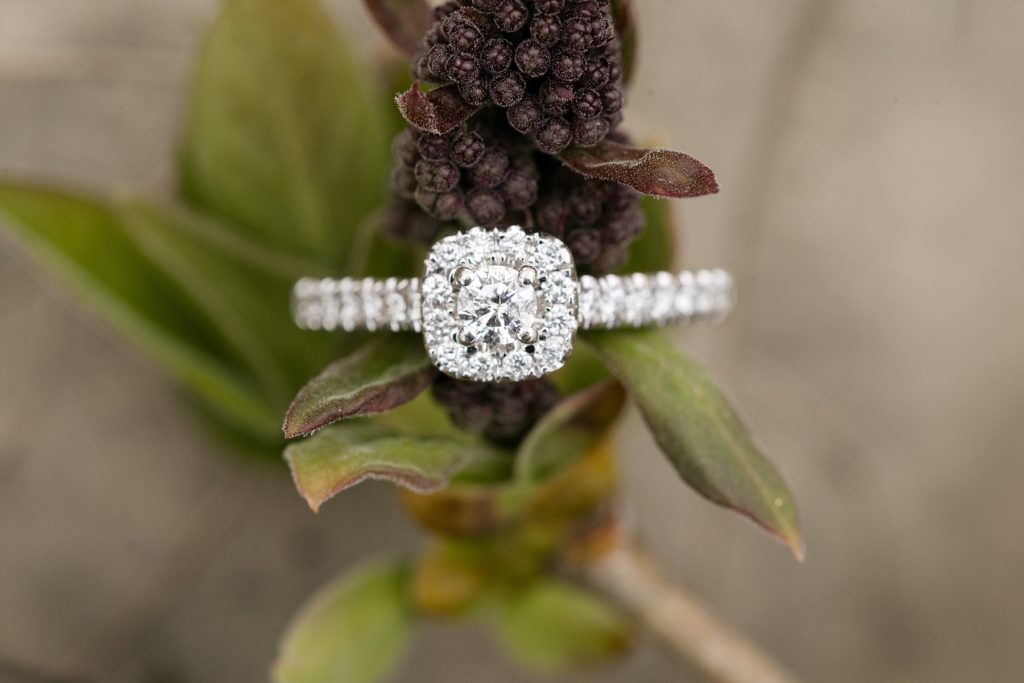 a small blossom and halo engagment ring
