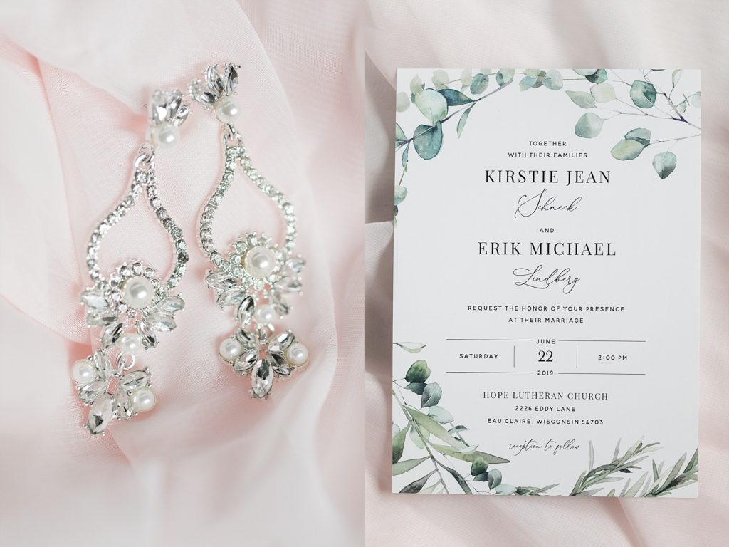 brides earrings and wedding invitation at The Florian Gardens in Eau Claire, WI