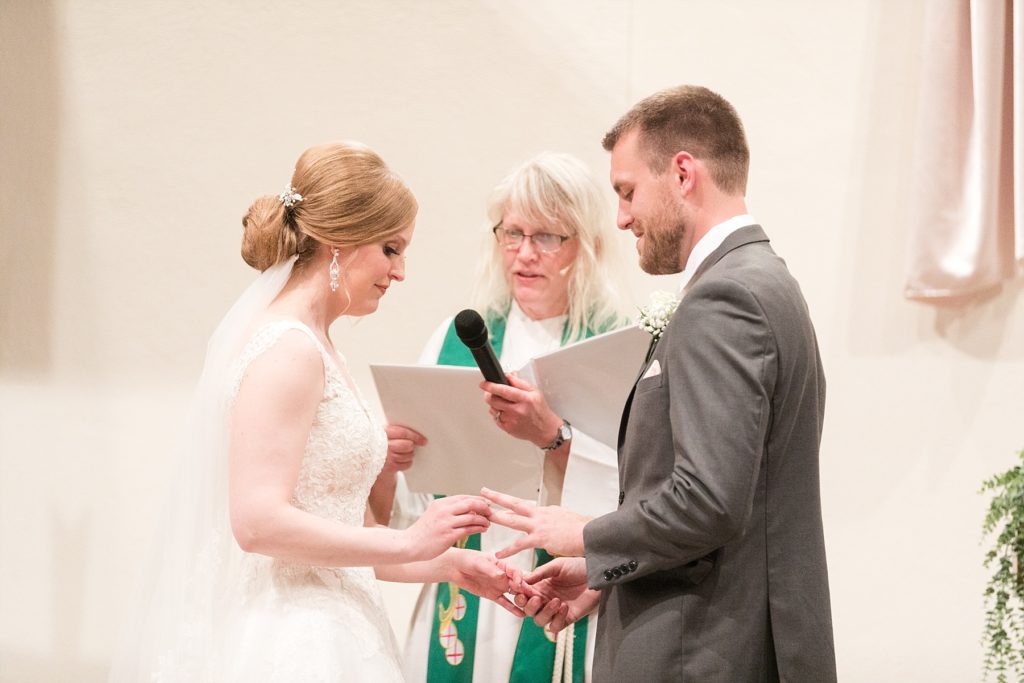 couple exchanging rings at wedding at Hope Lutheran Church in Eau Claire