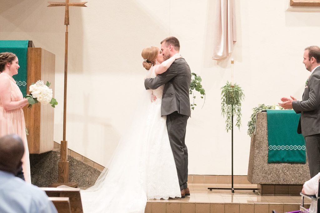 couple and their first kiss at Hope Lutheran Church in Eau Claire