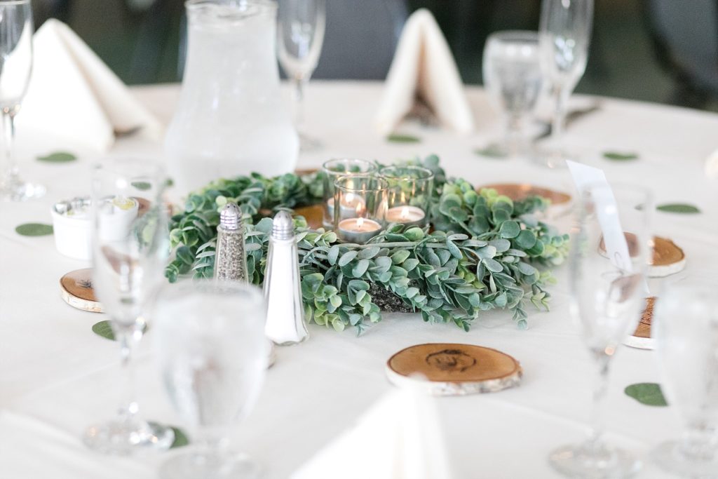 table decor of candles and wood slabs at wedding atThe Florian Gardens in Eau Claire