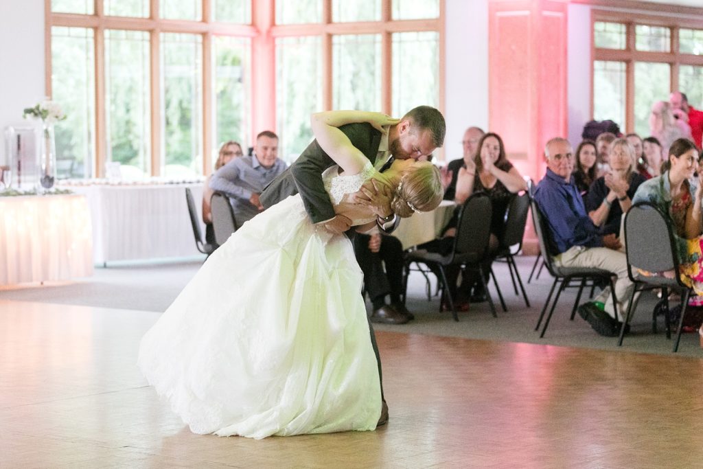 couple dipping during first dance at wedding atThe Florian Gardens in Eau Claire