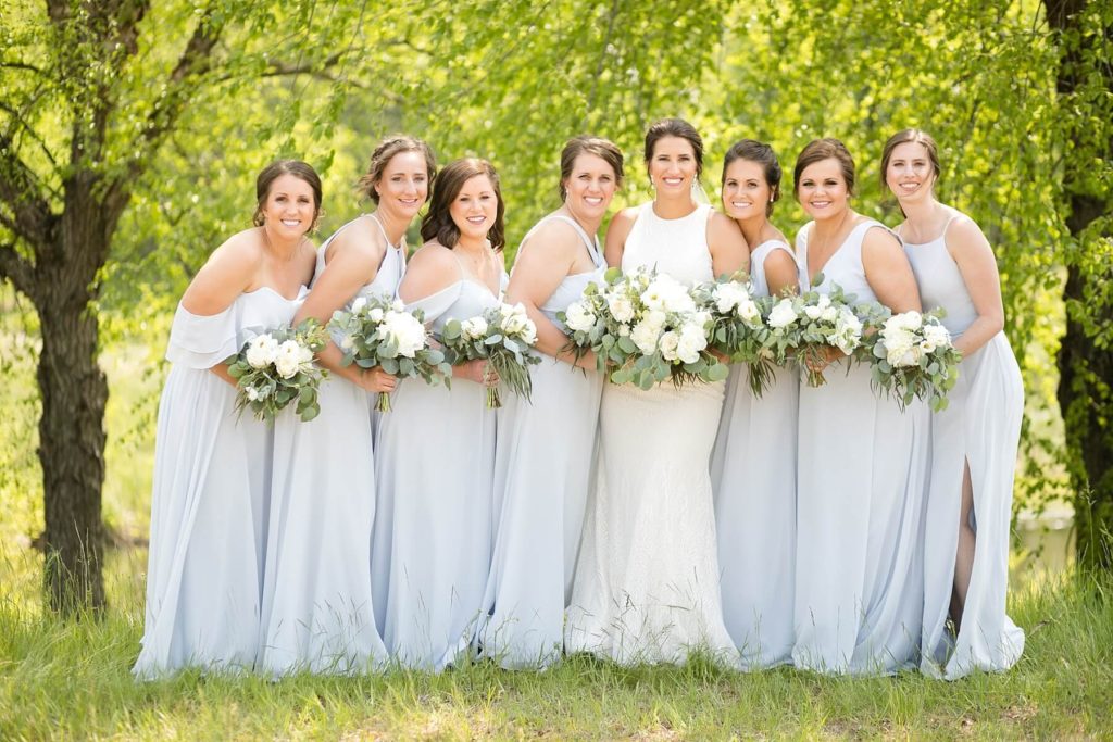 bride and bridesmaids in baby blue dresses at the Florian Gardens in Eau Claire