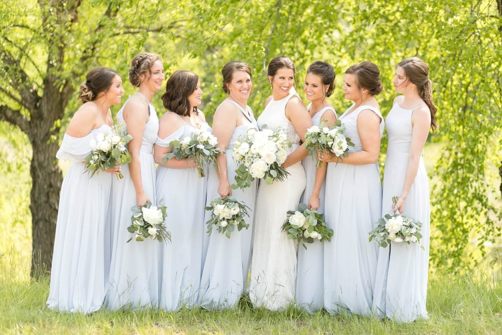 bride and bridesmaids laughing at the Florian Gardens in Eau Claire