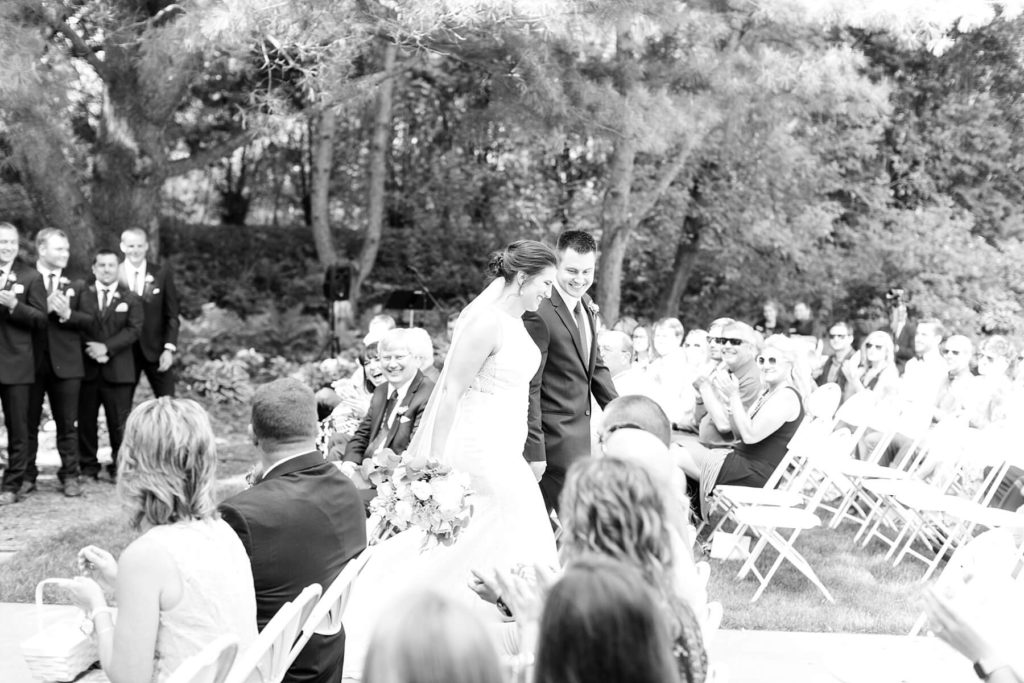 bride and groom during processional at the Florian Gardens in Eau Claire