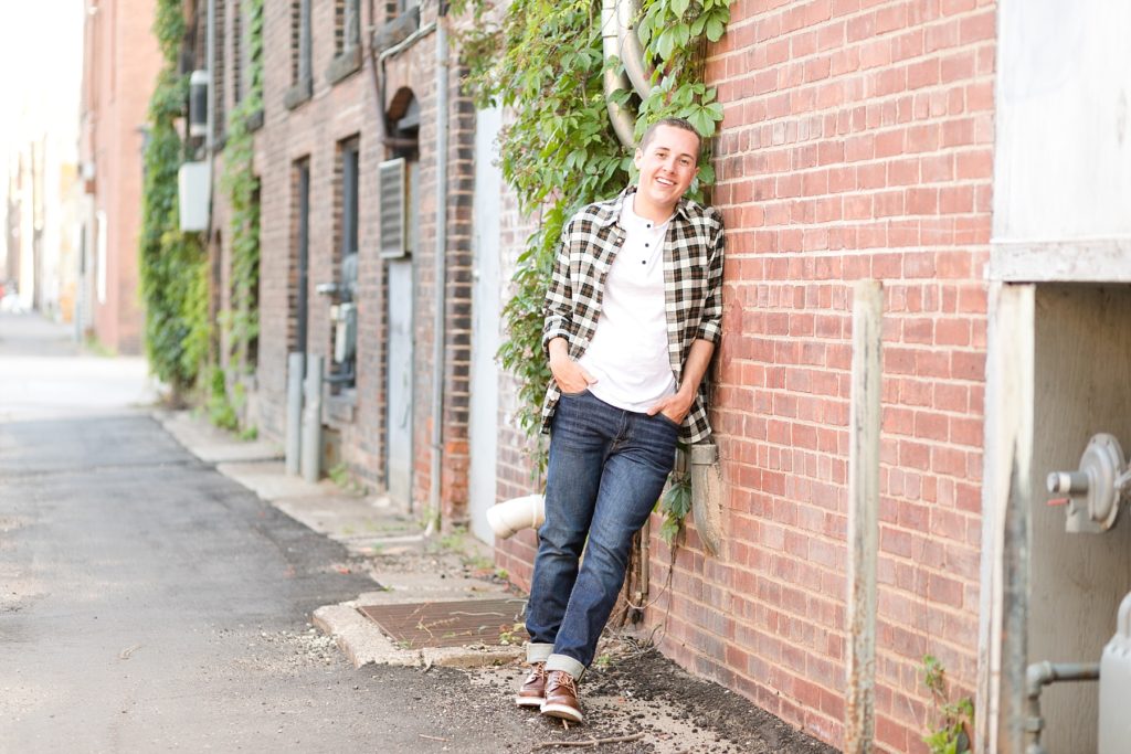 boy in an alley in eau claire for his senior photos