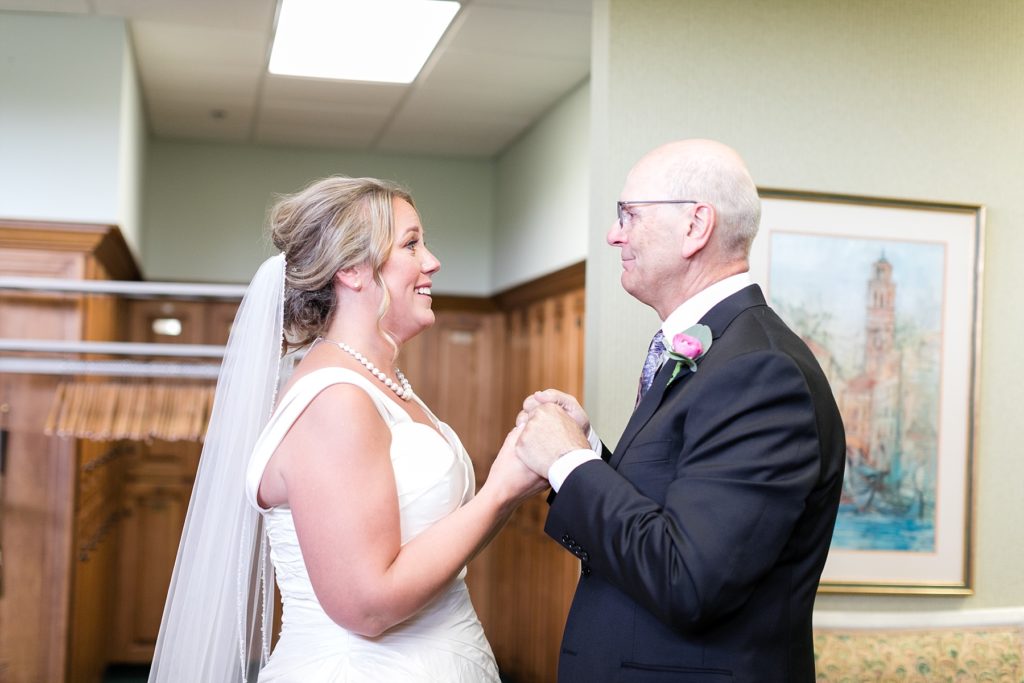 bride and father share a moment together before the wedding ceremony at the Eau Claire Golf & Country Club