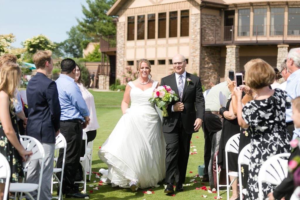 father walking daughter down the aisle at the Eau Claire Golf & Country Club