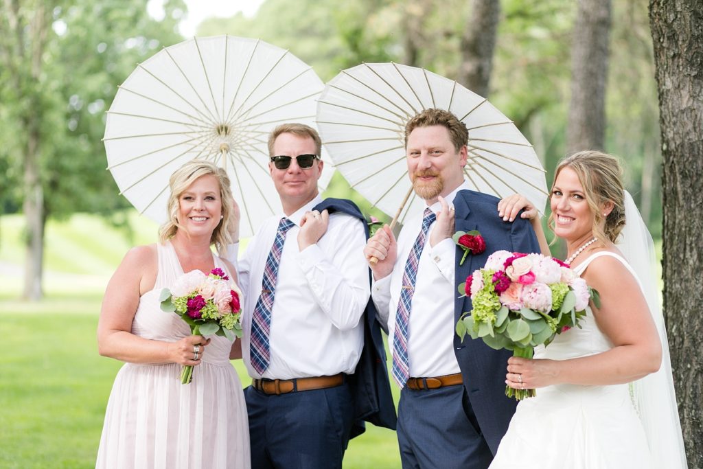 bridal party with umbrellas at the Eau Claire Golf & Country Club
