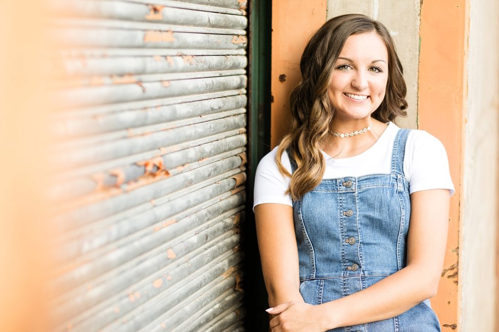 Senior Photo on door with a denim dress at Banbury Place in Eau Claire