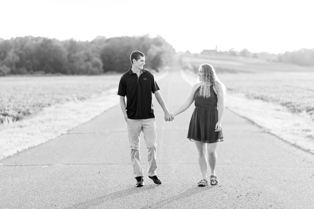 couple in a black and white photo looking at each other and holding hands for their Wisconsin engagement pictures