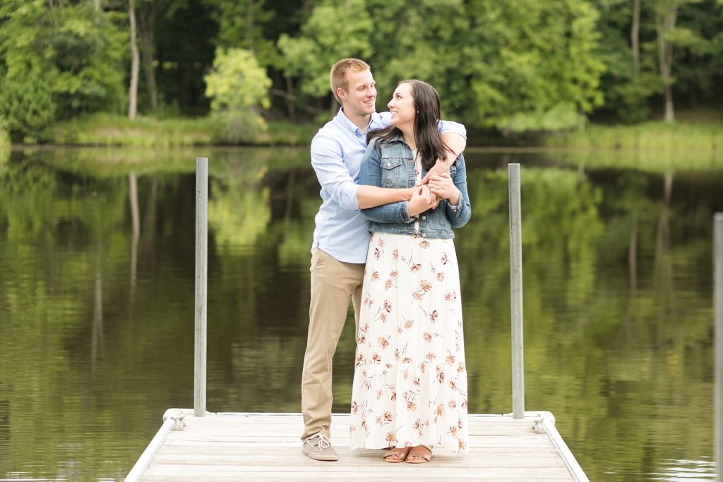 couple on a dock over a lake in Brunet Island State Park for their engagement pictures