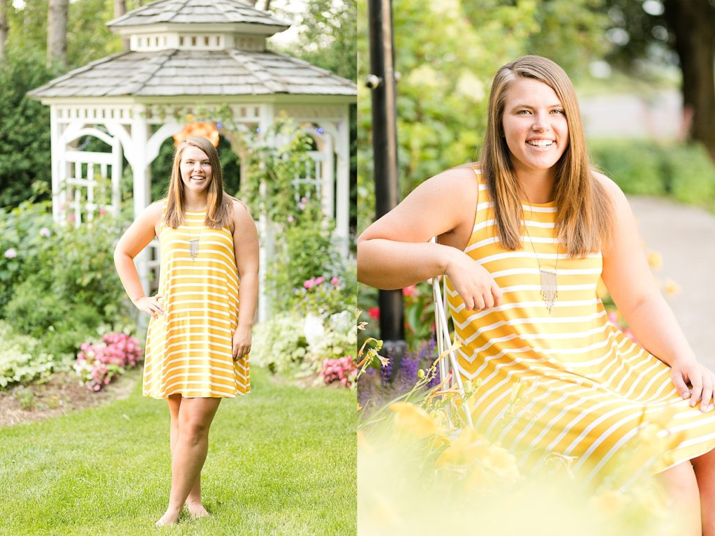 girl in a flower garden in a yellow striped dress for her senior photos in Chippewa Falls, WI