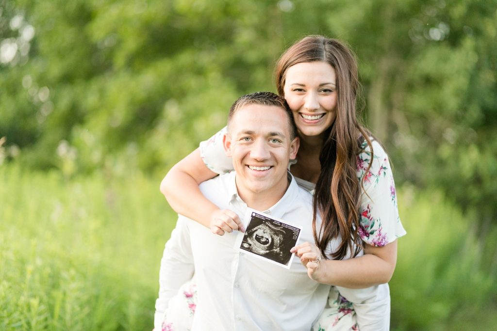 couple holding an ultrasound photo for their pregnancy announcement session in Wisconsin