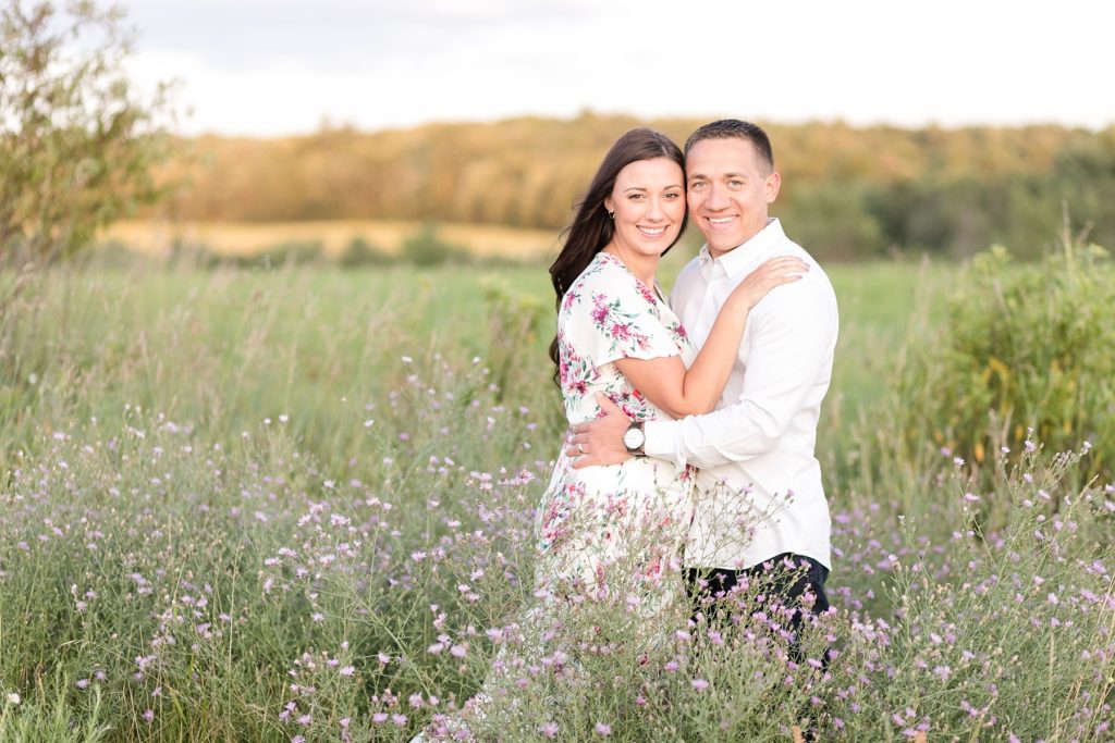 couple in a field of purple flowers for their anniversary session in Eau Claire