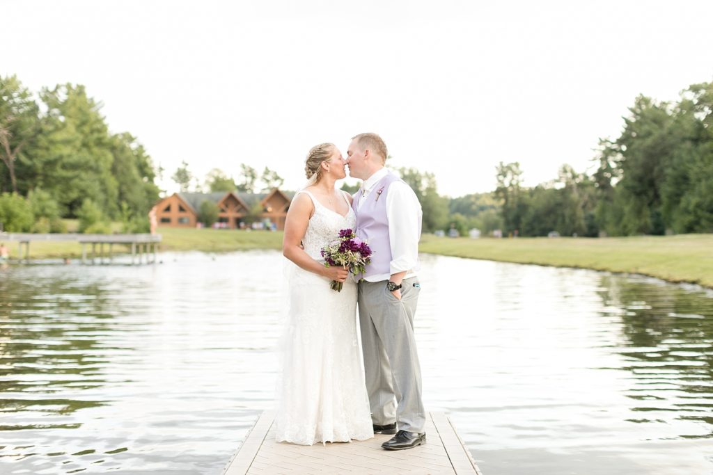couple kissing on the dock for their wedding at Three Bears Resort in Warrens, WI