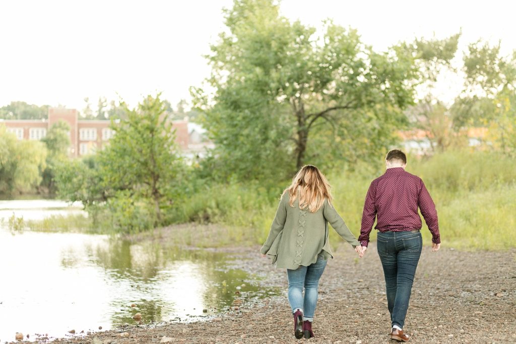 couple on a riverbed near UW Eau Claire for their engagement session