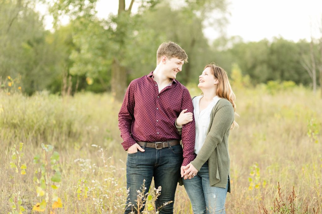 couple in tall grass at Owen park in Eau Claire for their engagement session