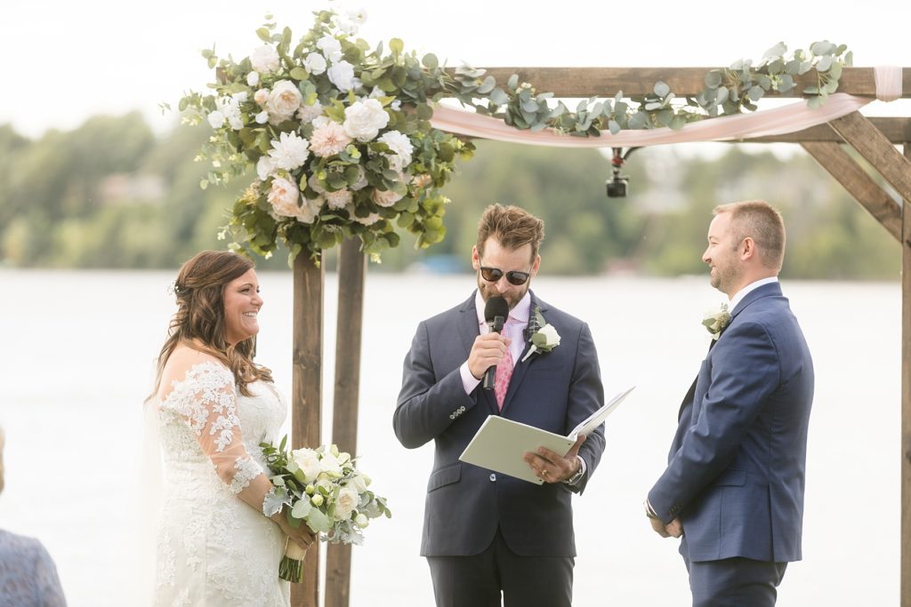 wedding ceremony on the lake under a pergola at Lake Wissota Golf & Events
